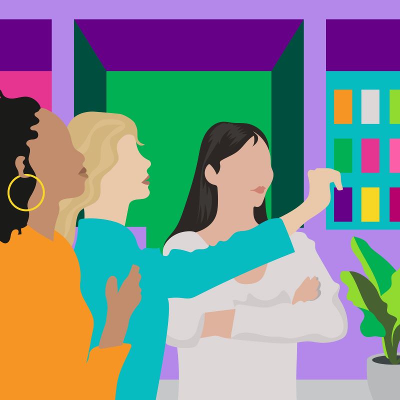 Illustration of three women standing together in an office setting, looking at something together. 